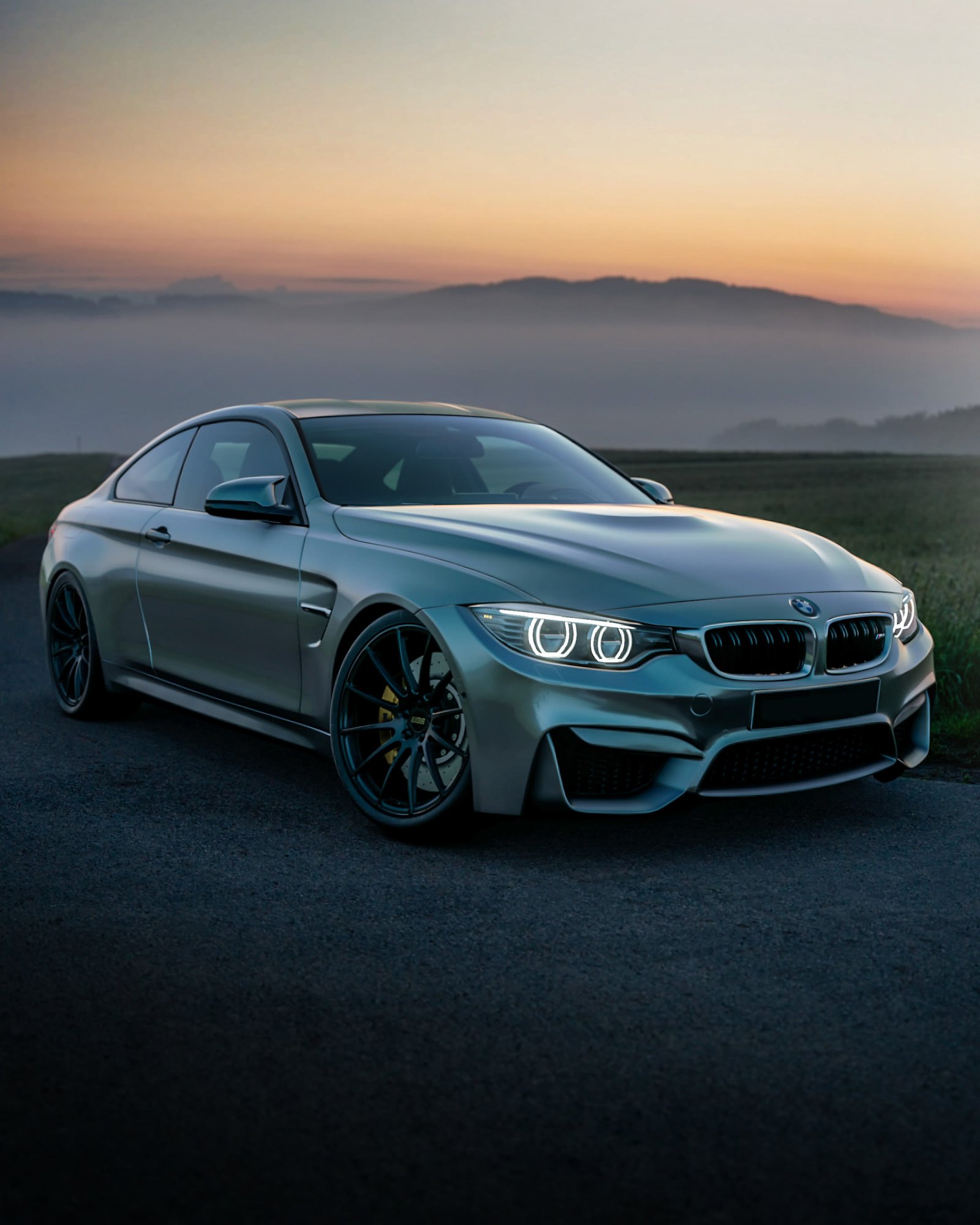 Luxury car on a mountain road at dusk